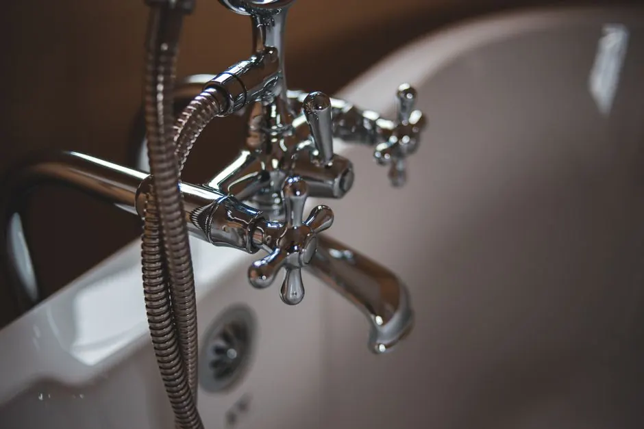 Elegant close-up of a shiny chrome faucet in a modern bathroom setting.